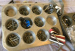 muffin tin full of screws